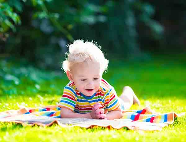 Toddler playing on the grass